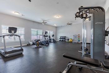 A well-equipped gym with treadmills, elliptical machines, and other exercise equipment.